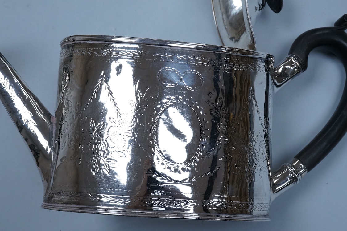A George III engraved silver oval teapot, makers mark RD?, London, 1794, together with one other Georgian silver teapot with associated silver cover, gross weight 26.8oz.